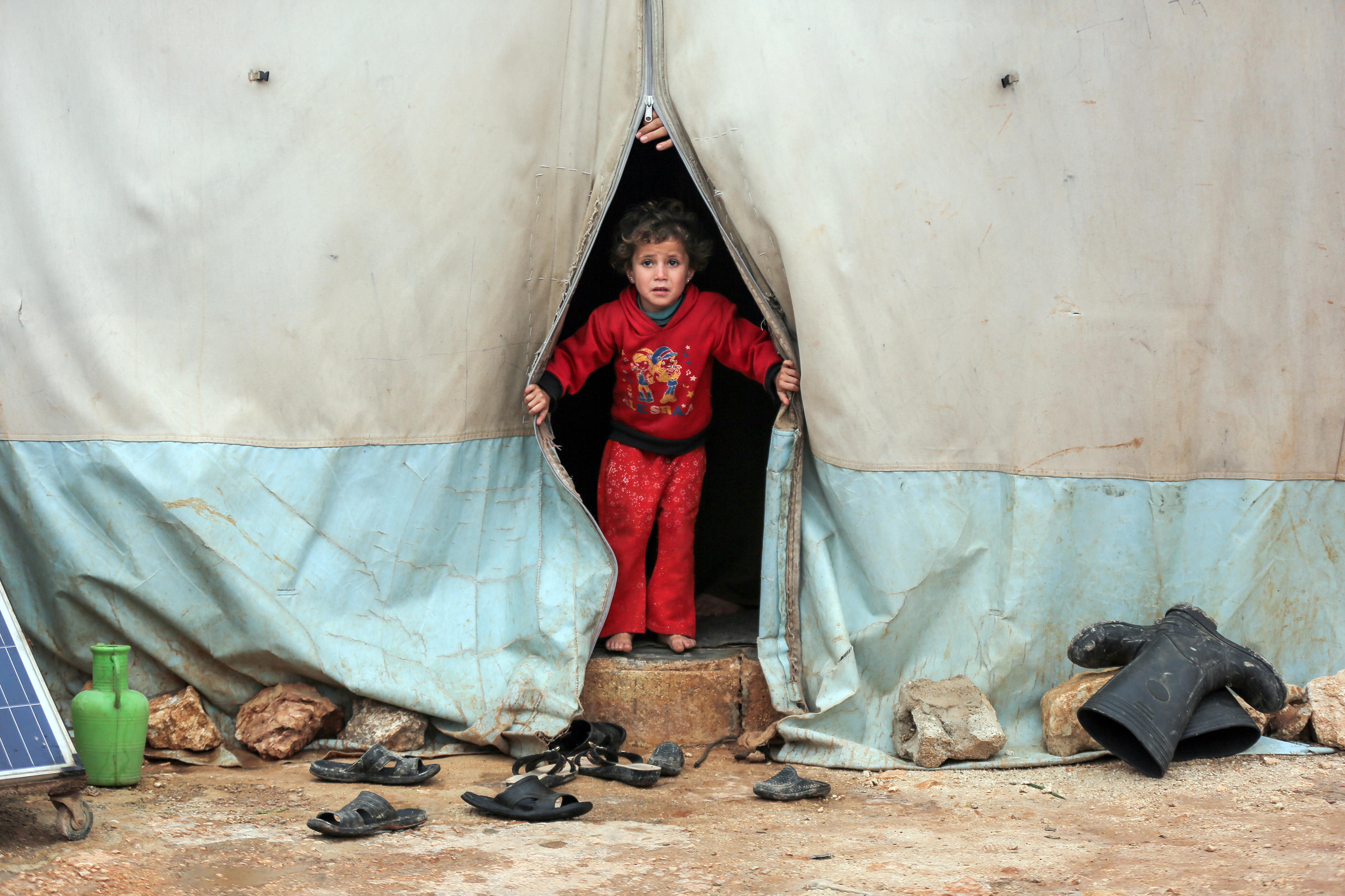 A child looks out of a tent in Kafr Losin camp in northwestern Syria in January 2021.