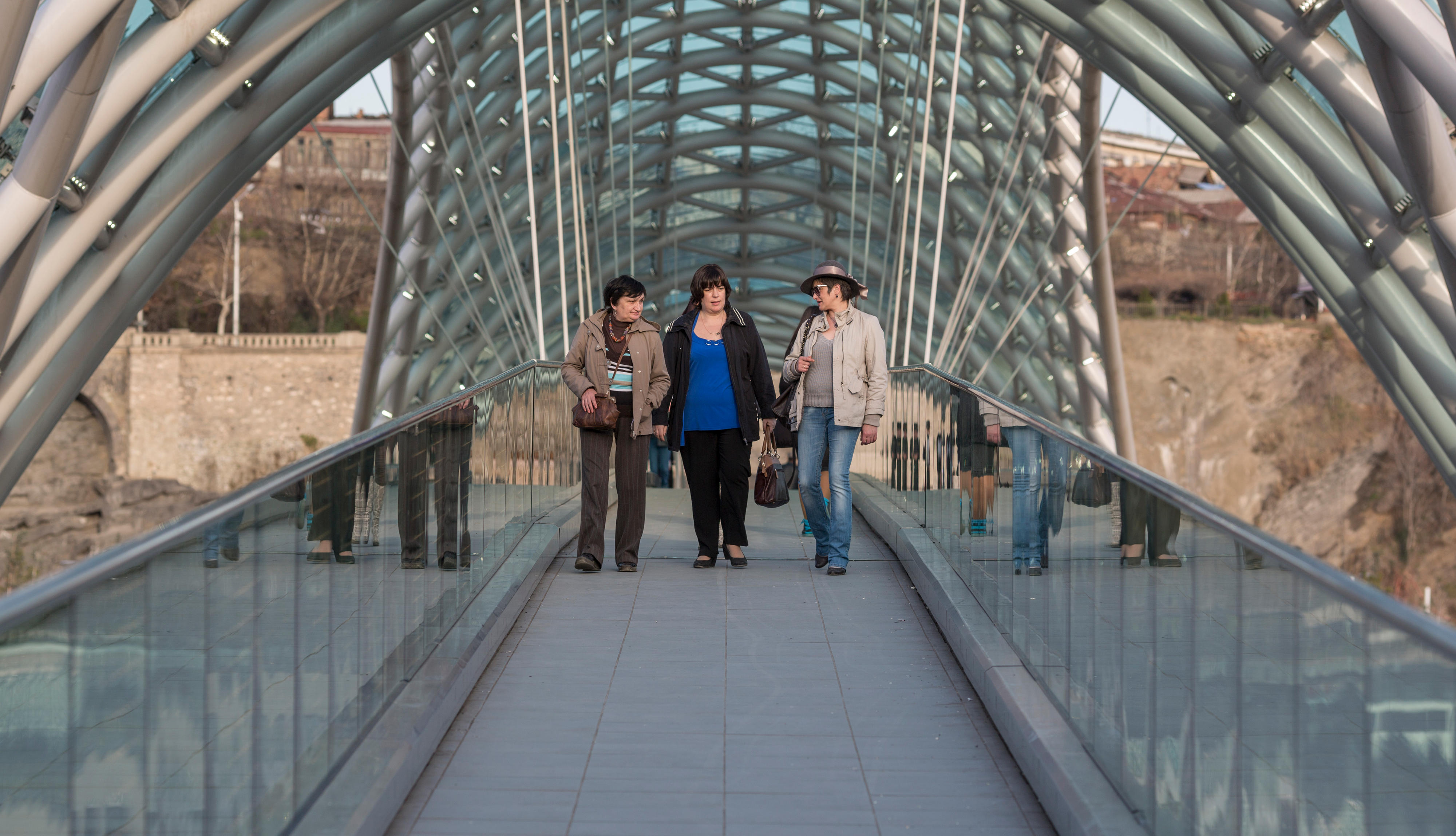 Pedestrians on the Peace Bridge in Tbilisi, Georgia