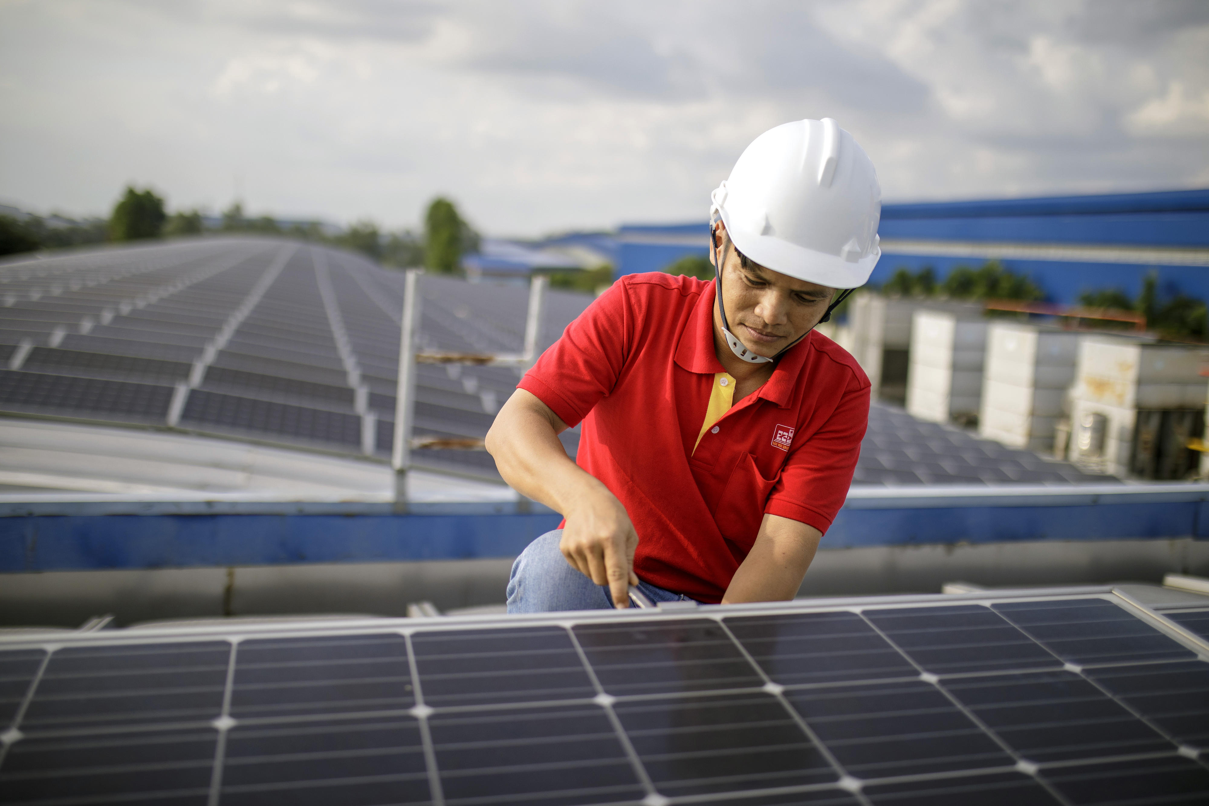 An employee of Sao Mai Corporation works on a rooftop solar installation in Vietnam.