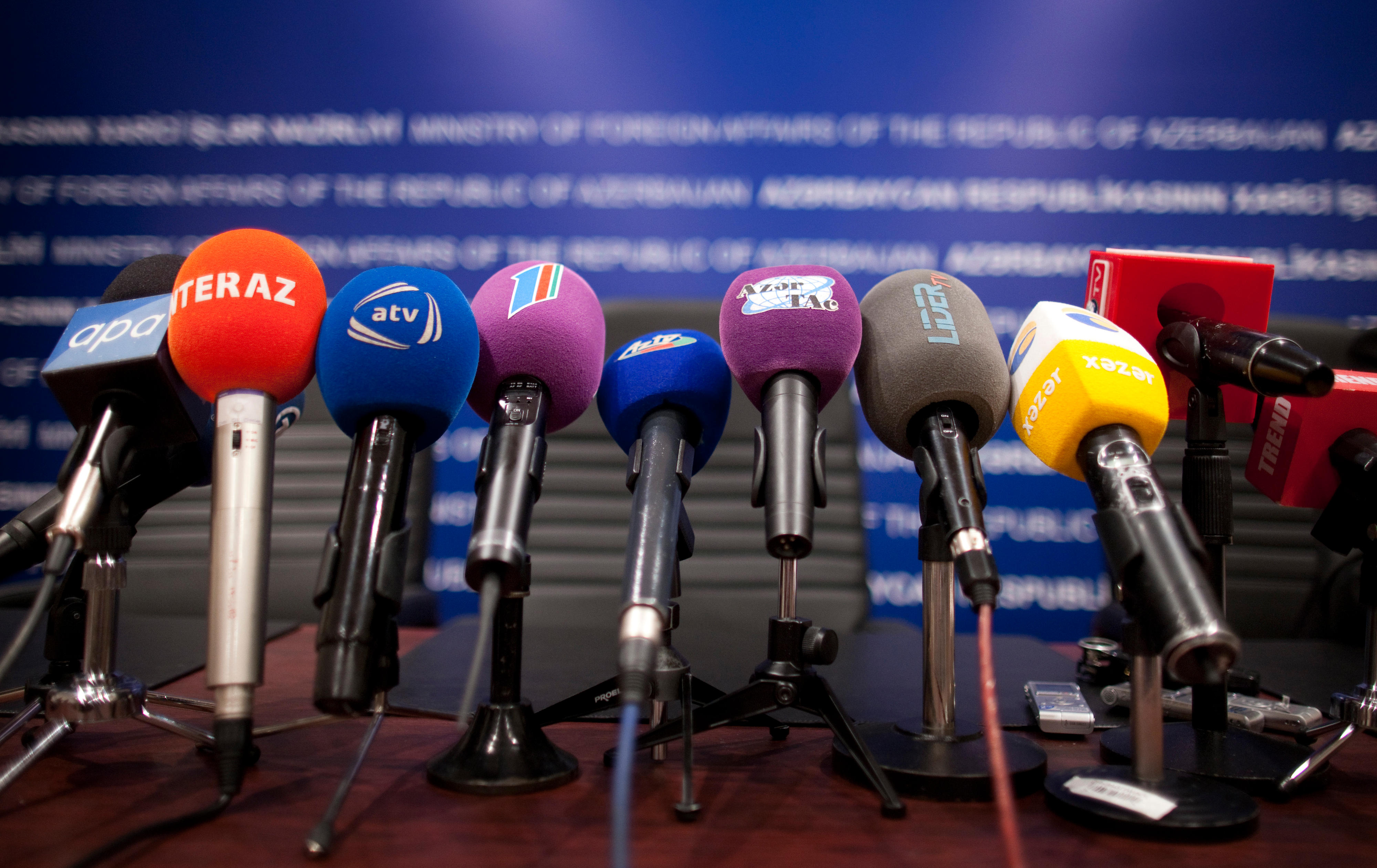 Microphones of journalists at a press conference in Baku, Azerbaijan