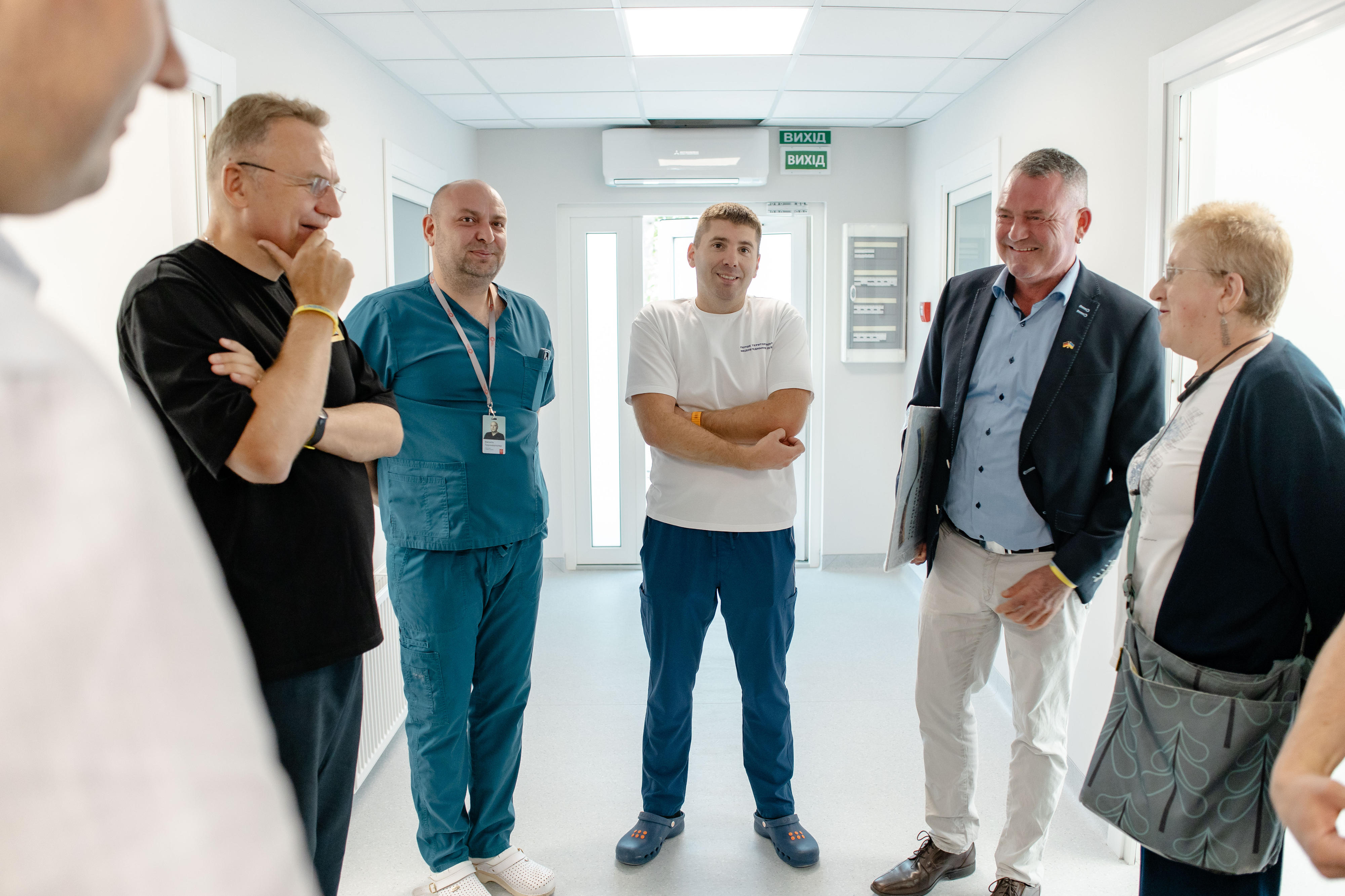 Clinic director V. guides visitors through the new modular diagnostics centre and the hospital extension in Lviv.