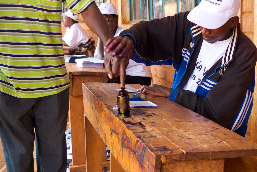 A voter in Burundi has his finger marked with ink.