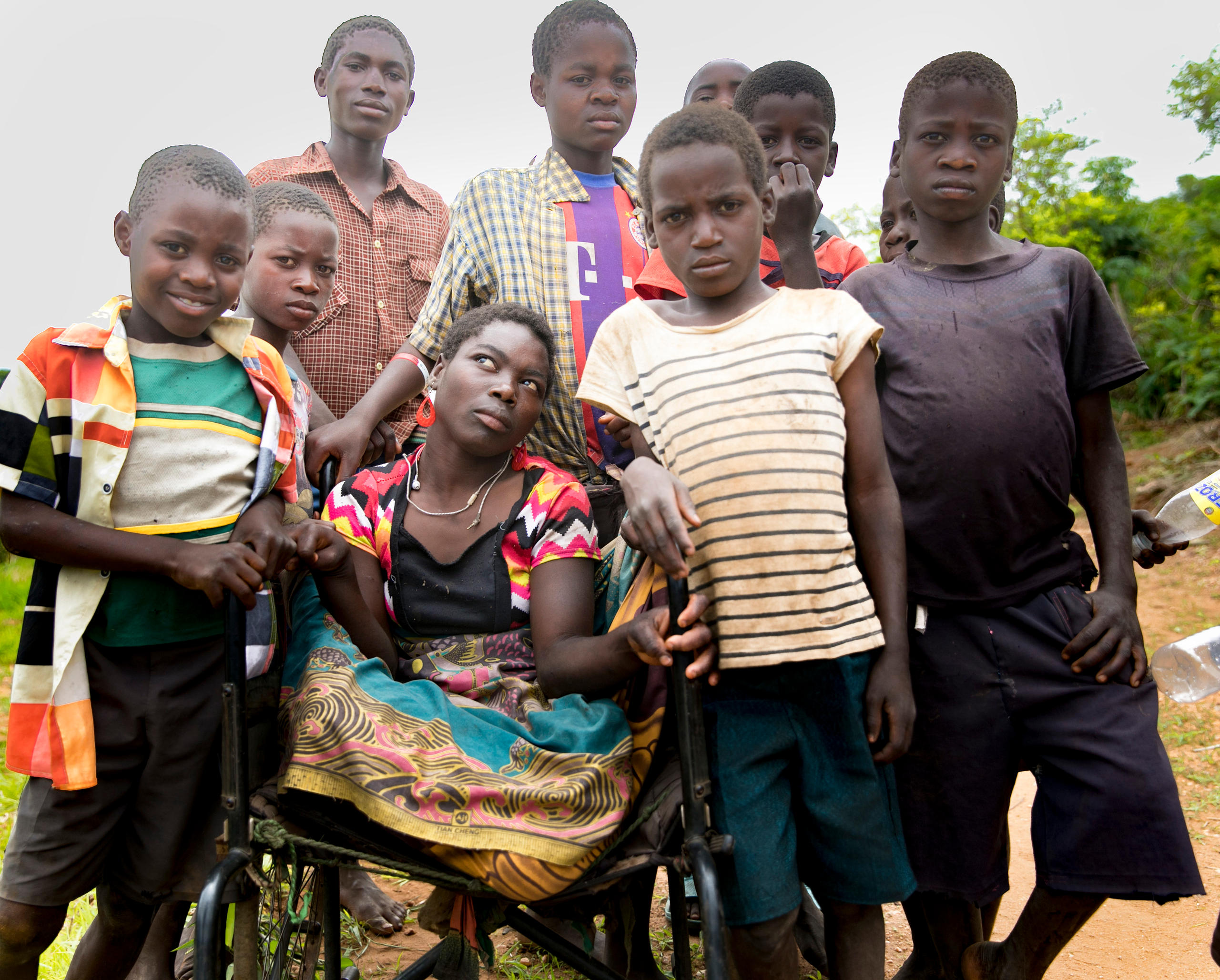 Foto von junger Frau im Rollstuhl umringt von Freunden