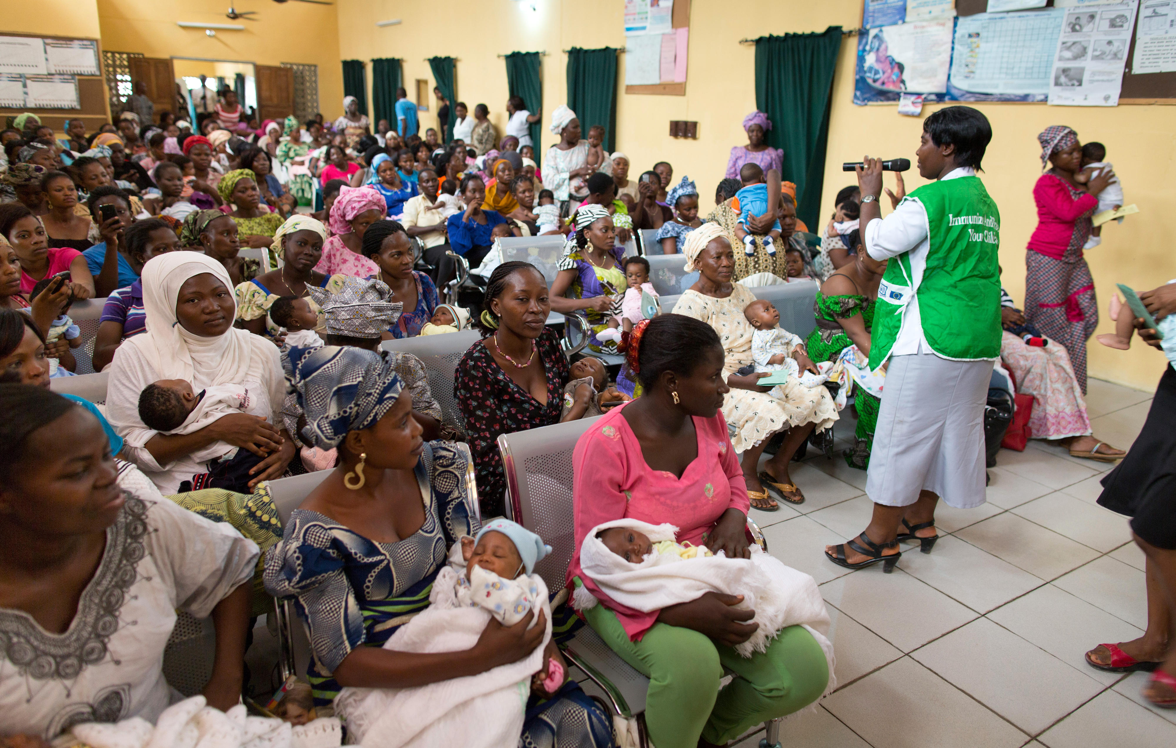 Picture of mothers with their babies in a waiting hall.