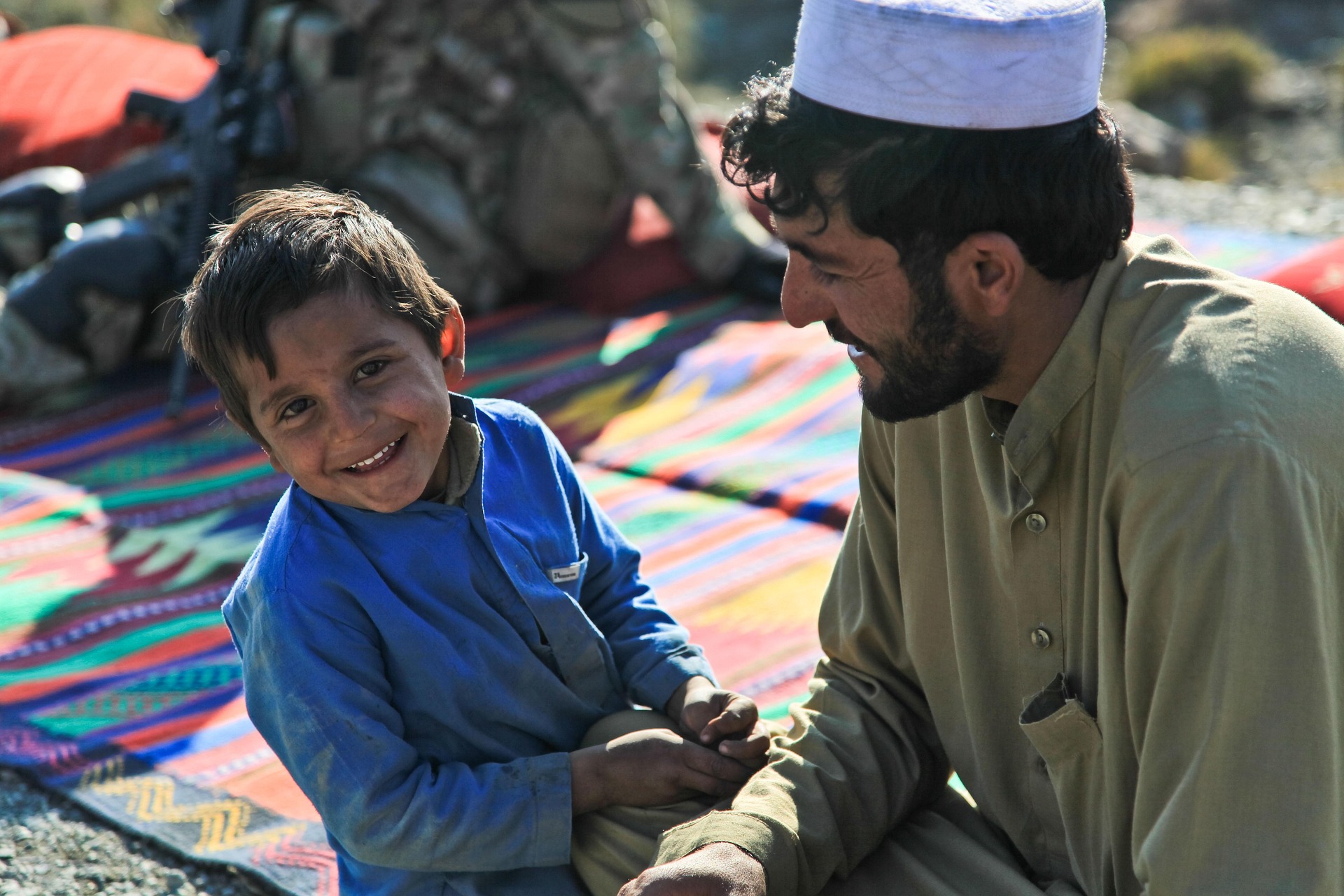 Photo of a smiling boy with his smiling father.