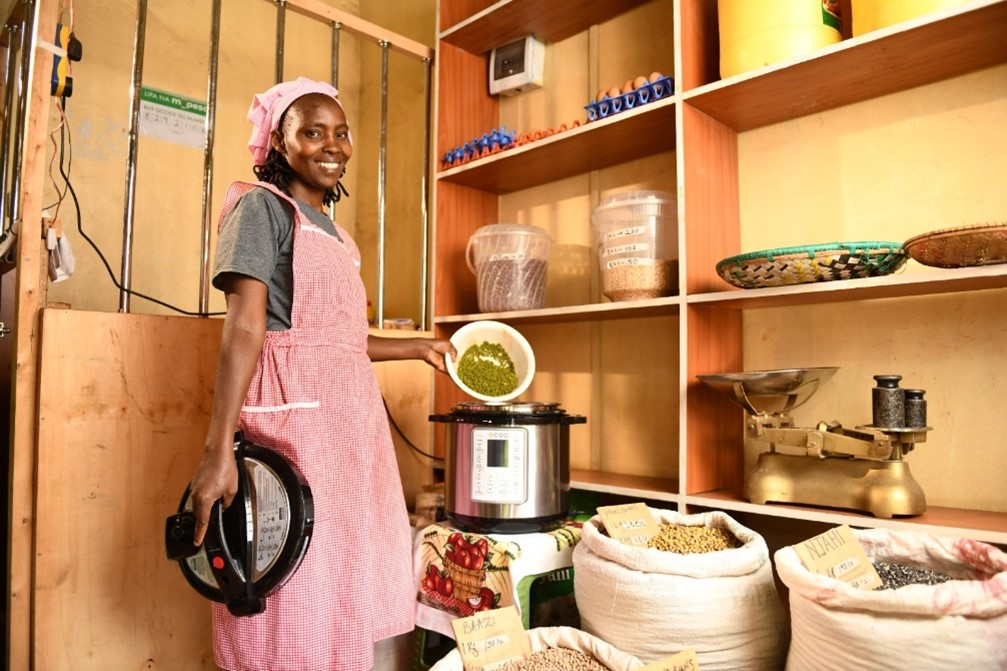 Business owner Margaret Wambui uses an electric pressure cooker