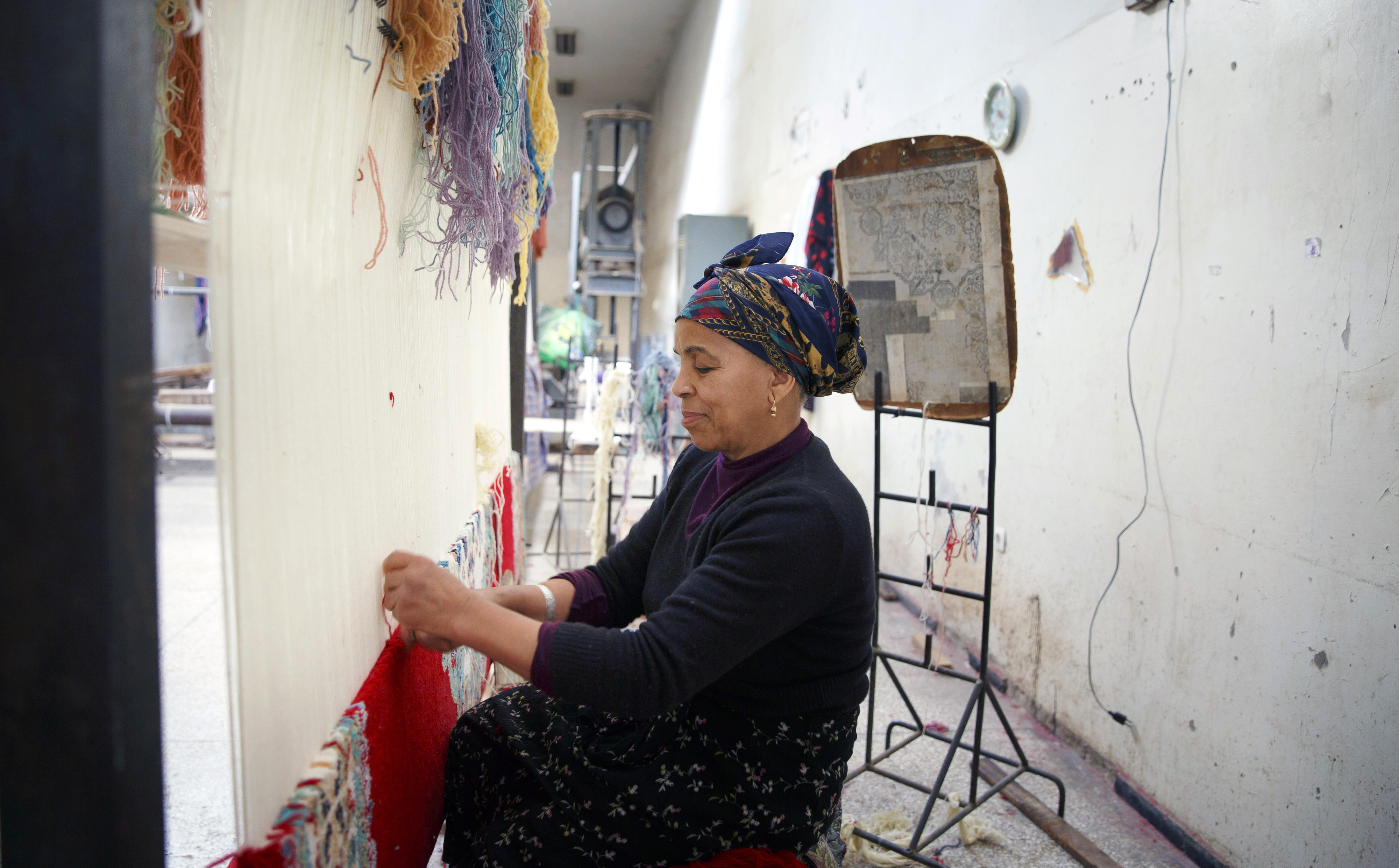 A woman making rugs at the arts and crafts centre in Meknes, Morocco