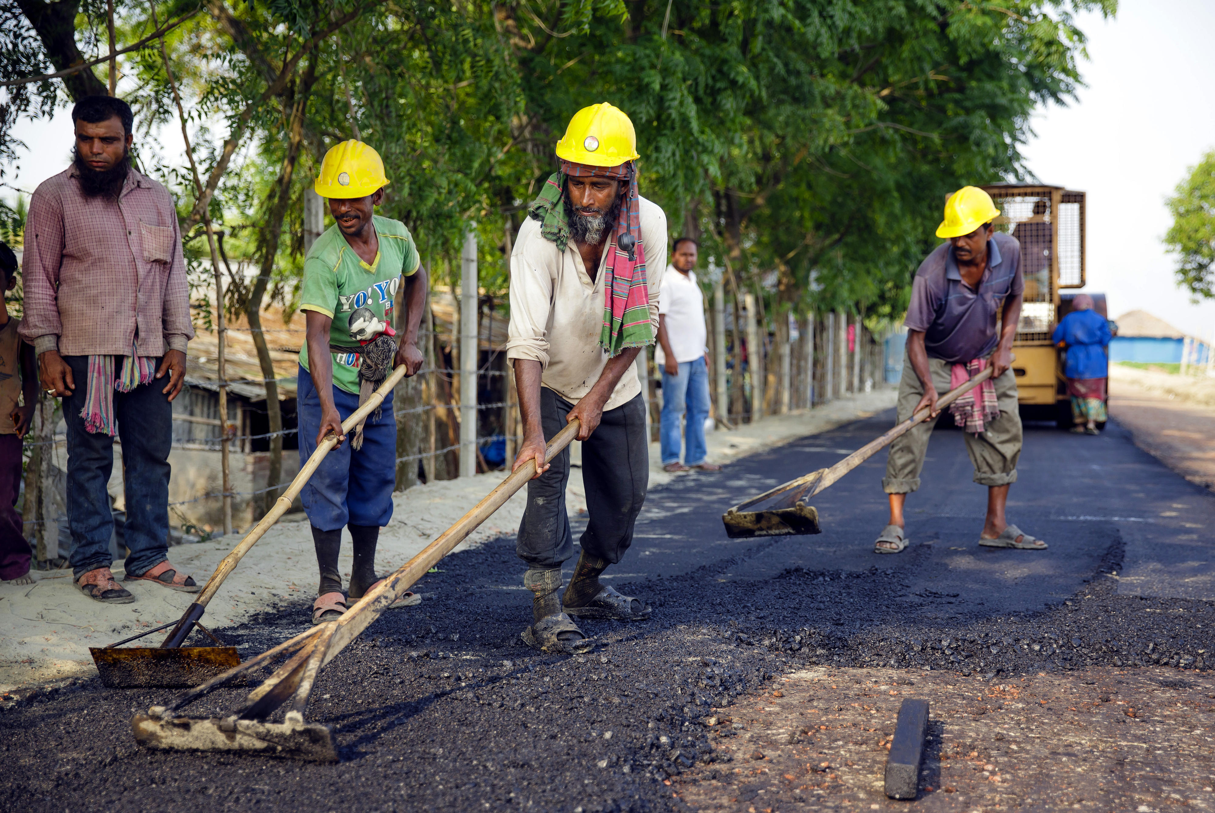 Workers building a new dam road in Khulna