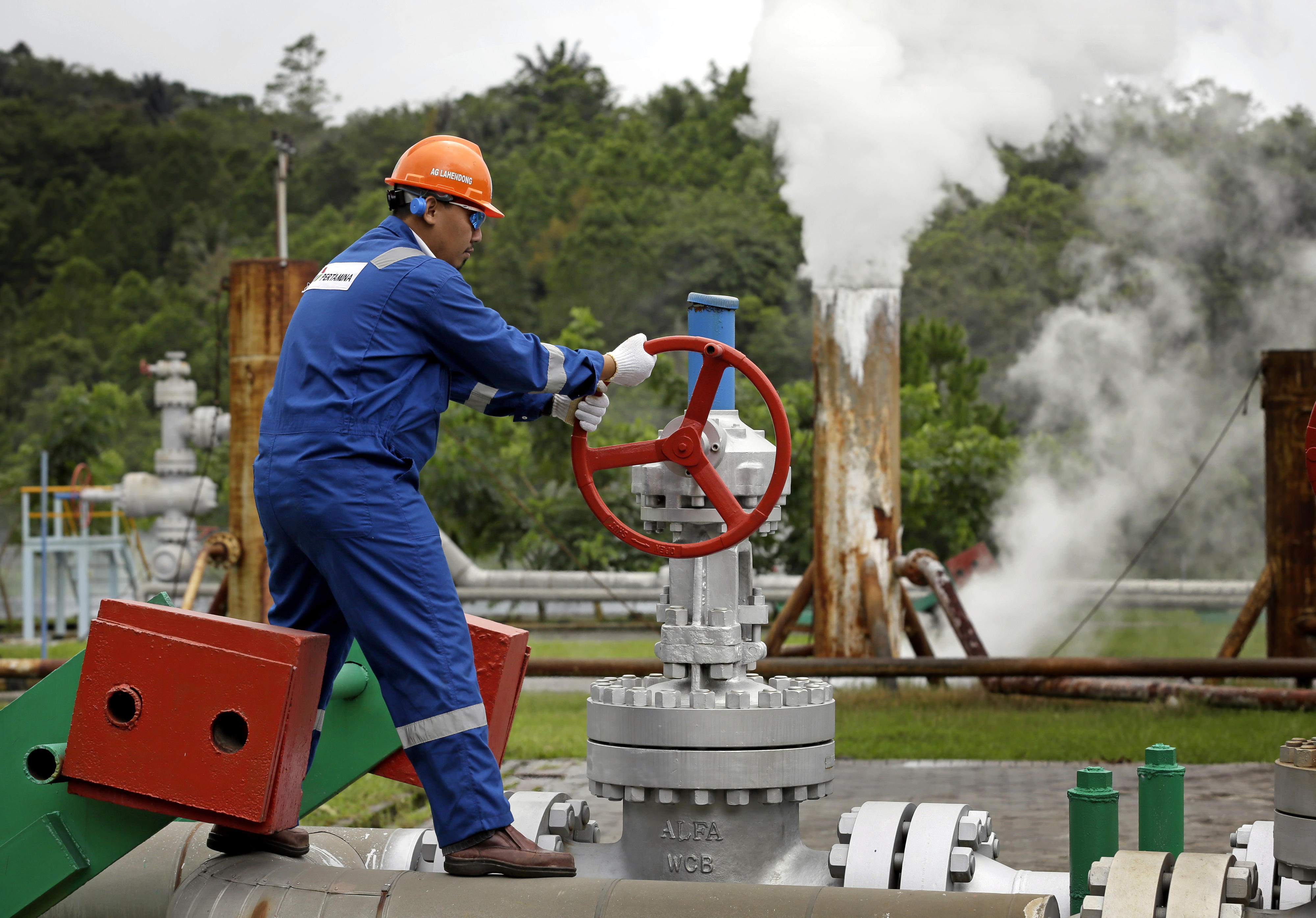 A worker at the Lahendong geothermal site on Sulawesi Island, Indonesia. The hot steam produced here is fed to a nearby power plant to generate electricity.