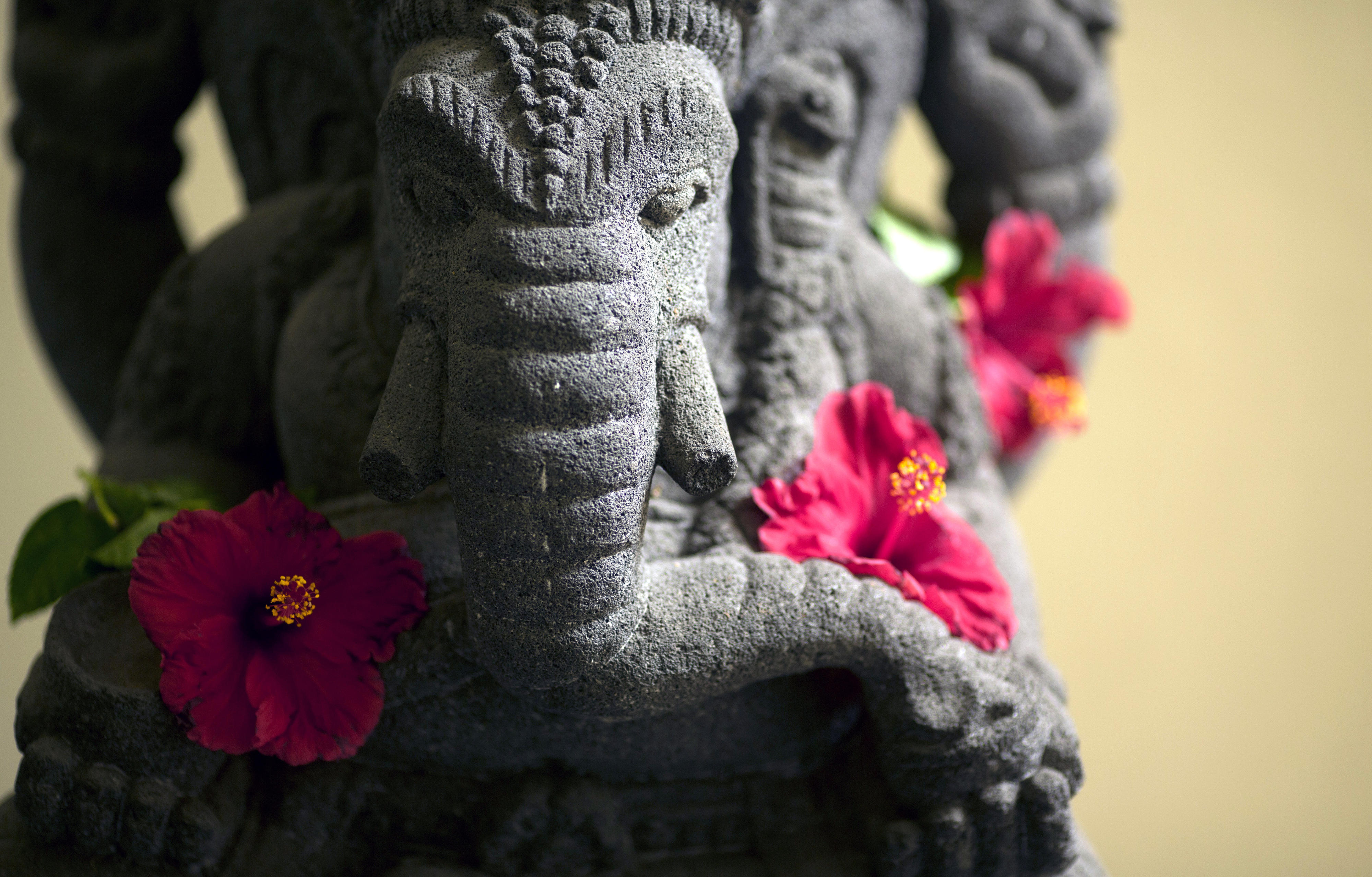 Stone elephant with hibiscus flowers, image of the Hindu deity Ganesha, Jakarta, Indonesia