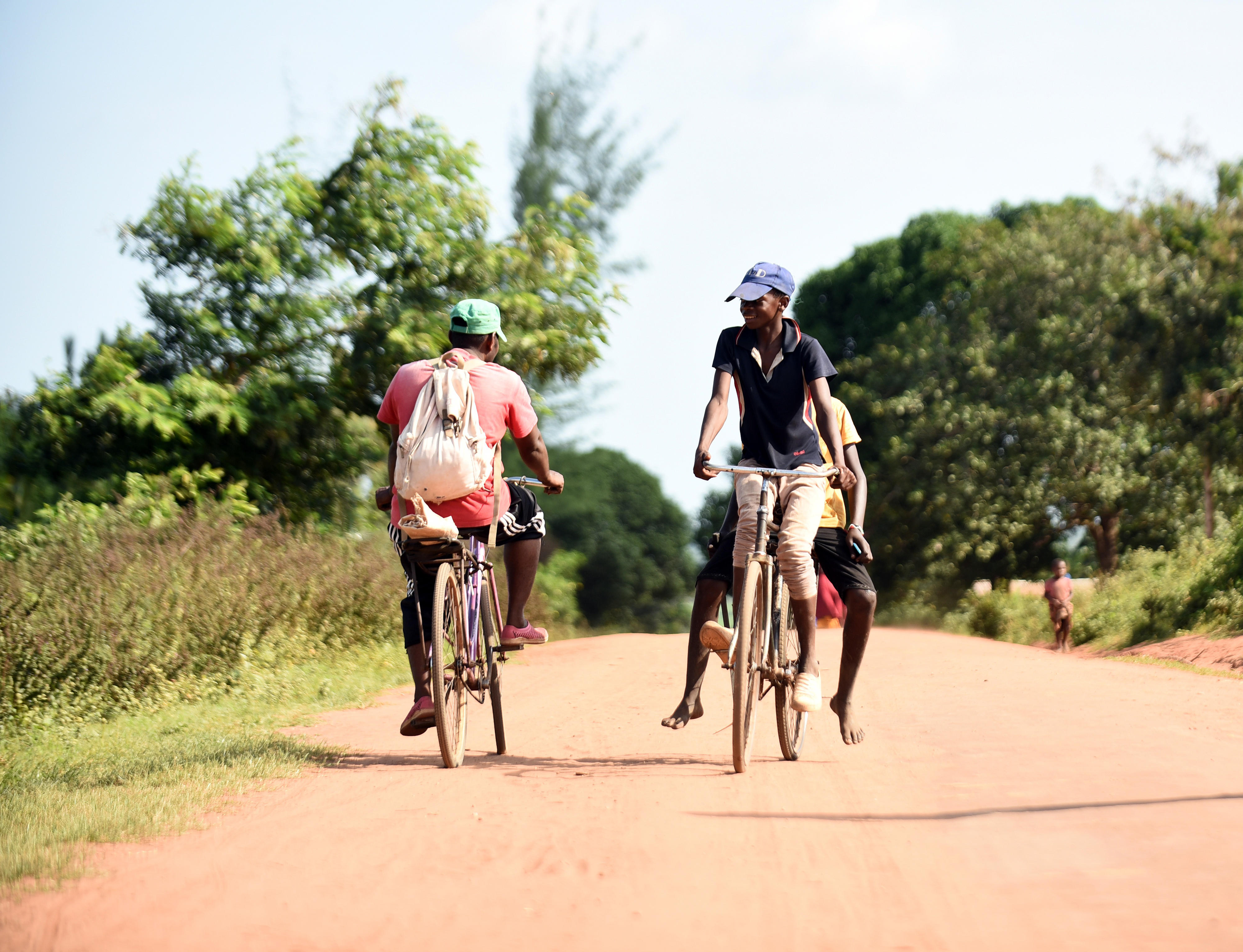 Teenagers on bicycles on a Kenyan country road