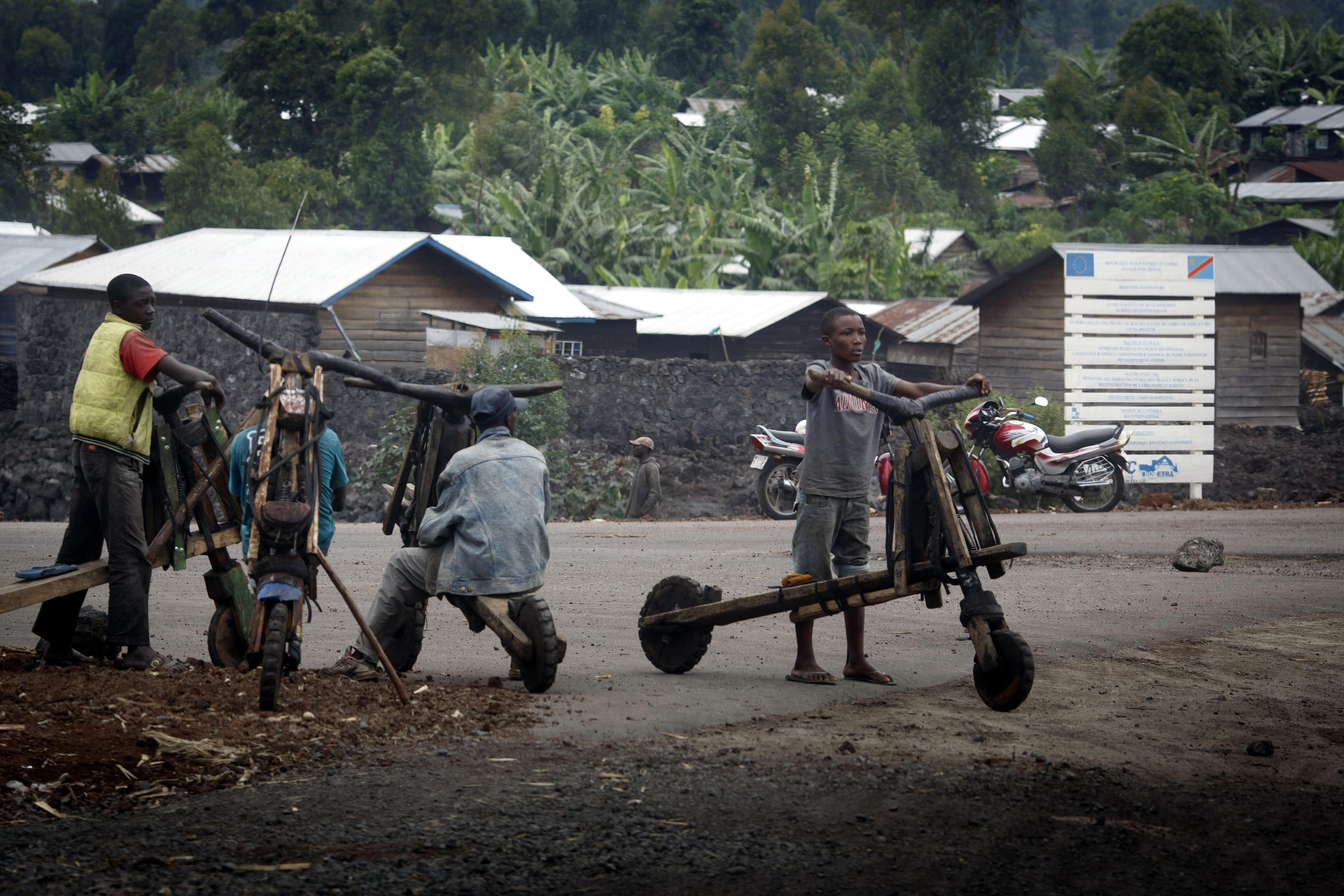 Men with so-called chukudus (freight scooters) in Goma, DR Congo