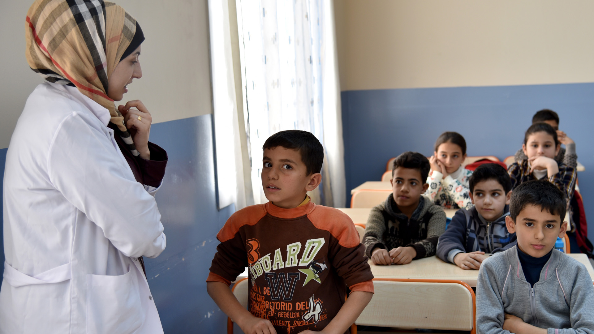 Teacher and students in the UNICEF school in Adana