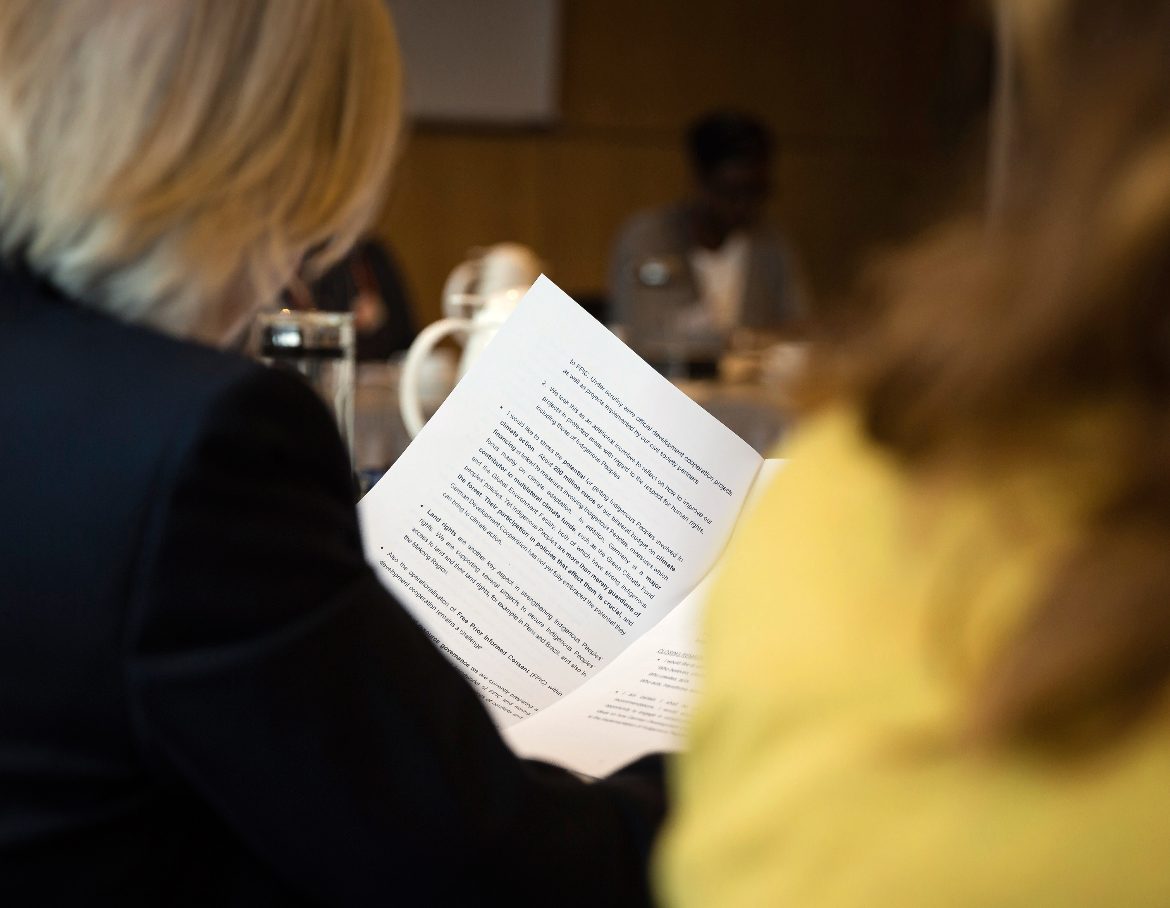 A conference participant studies a speech manuscript.