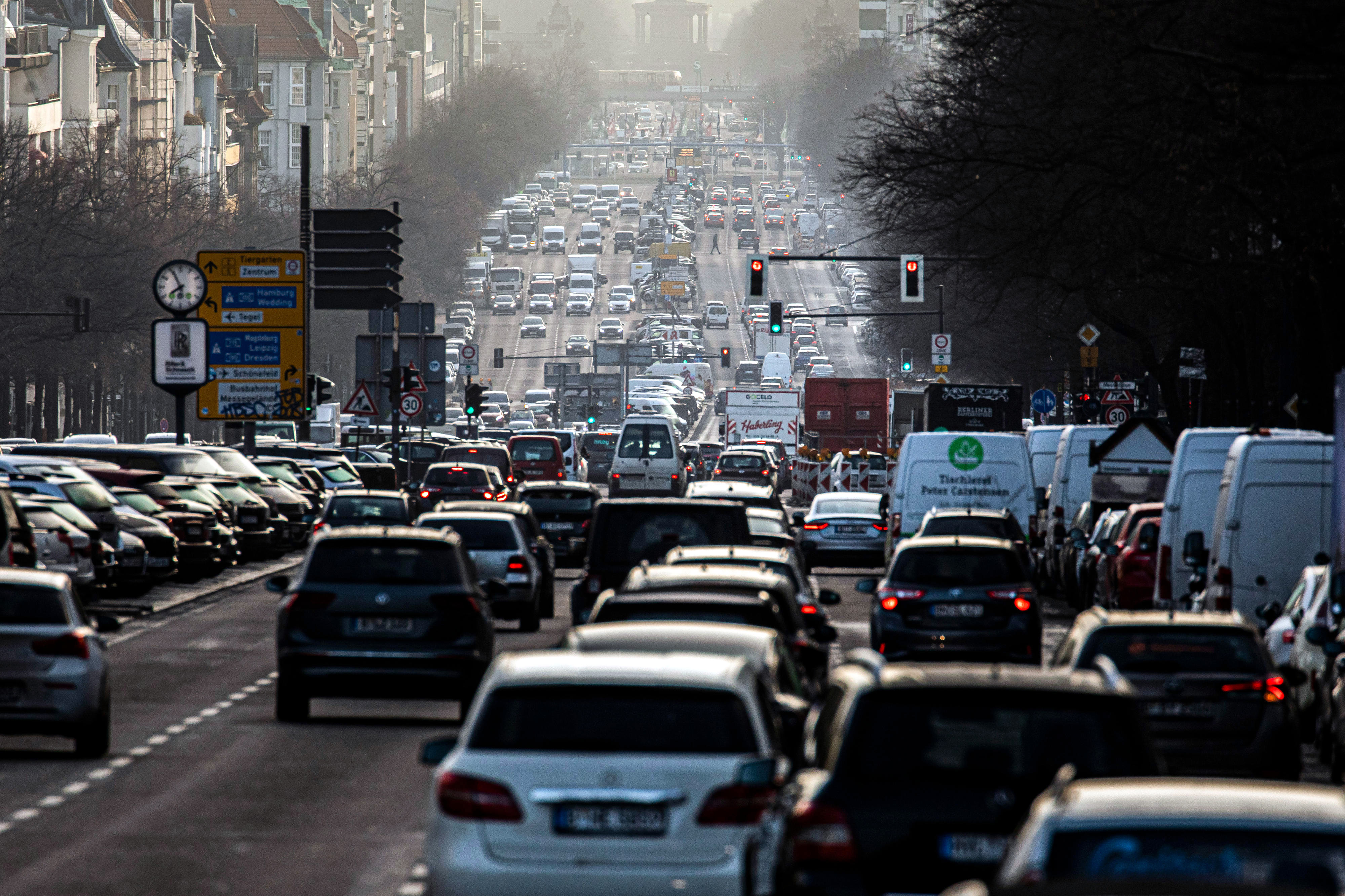 Road traffic in Berlin, numerous cars driving closely packed on a multi-lane road